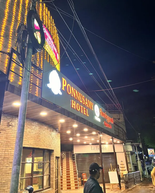 Ponnusamy Egmore entrance and illuminated sign photographed at night