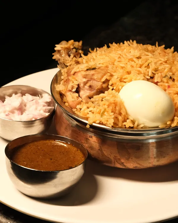 Biryani and Kari Soru served in traditional copper vessels at Ponnusamy Hotel Egmore